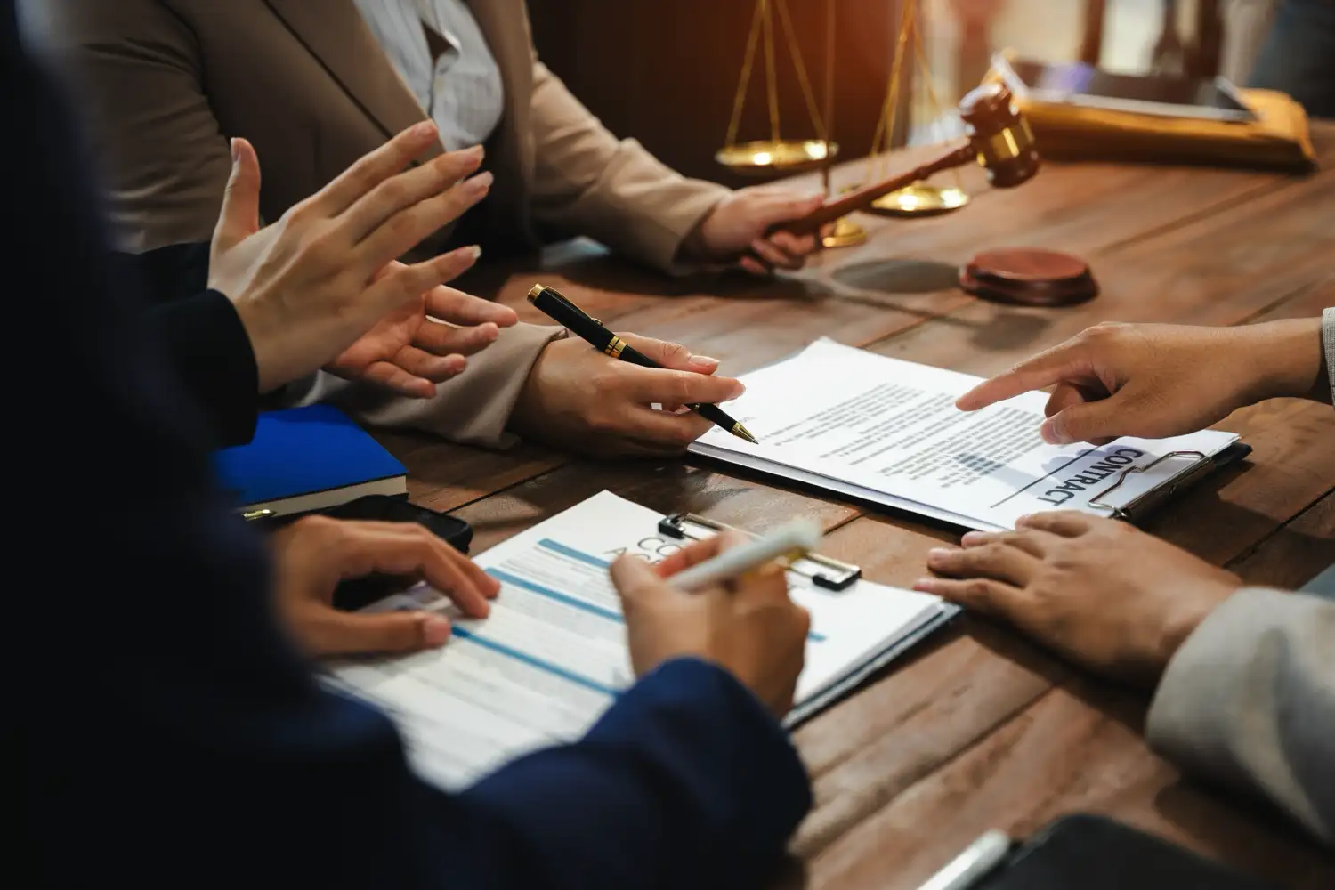 A group of people looking over a contract in a courtroom