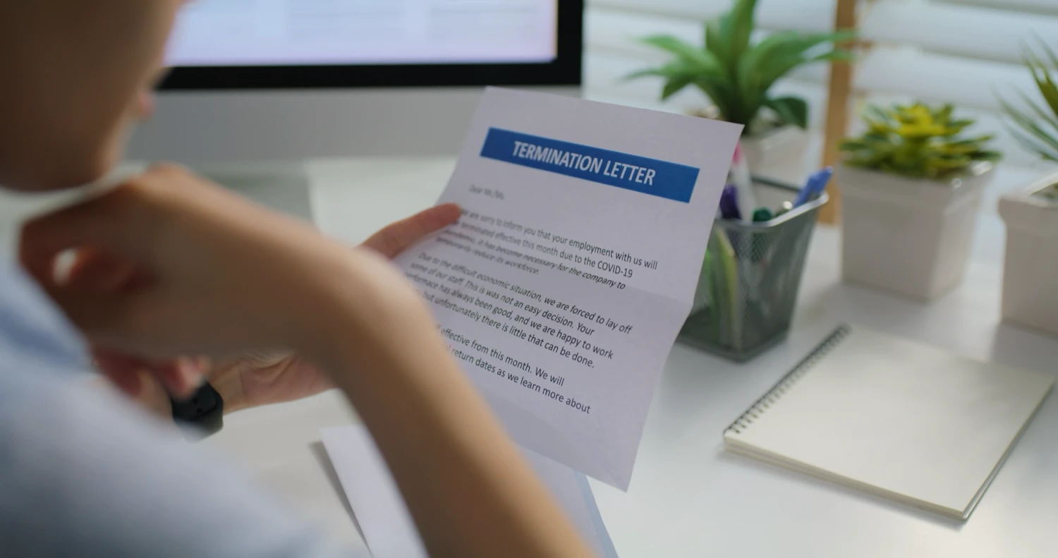 Woman reading a letter of termination.